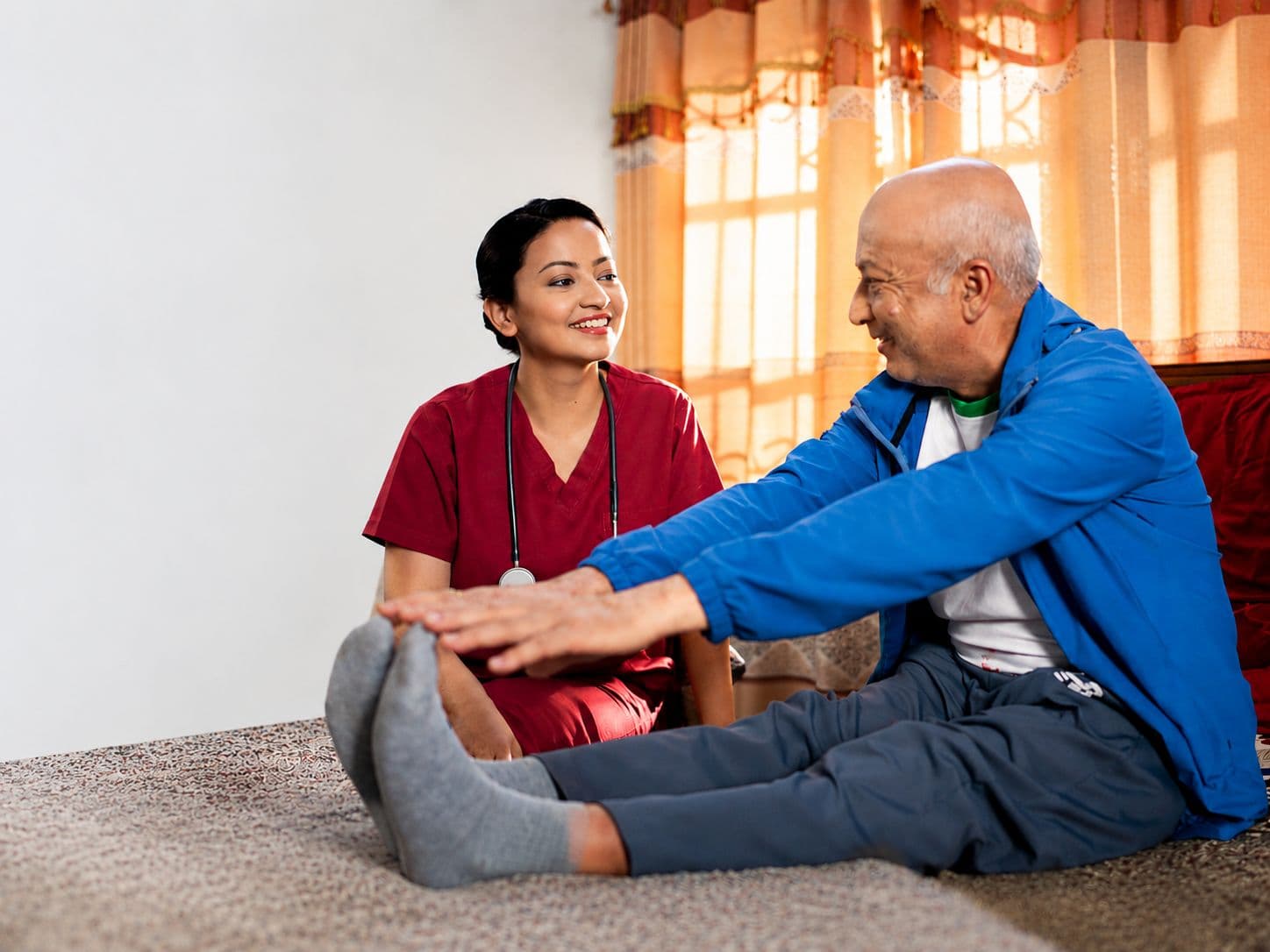 A Parivar nurse caring for an elderly patient at home